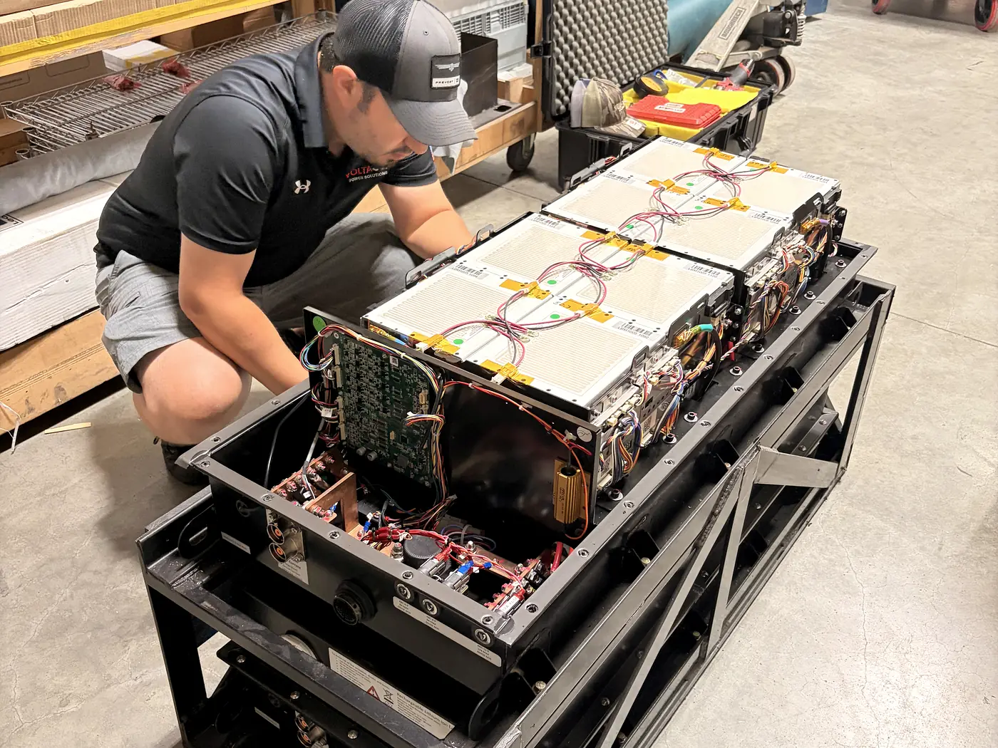 Voltagen technician assembling a lithium battery module rack